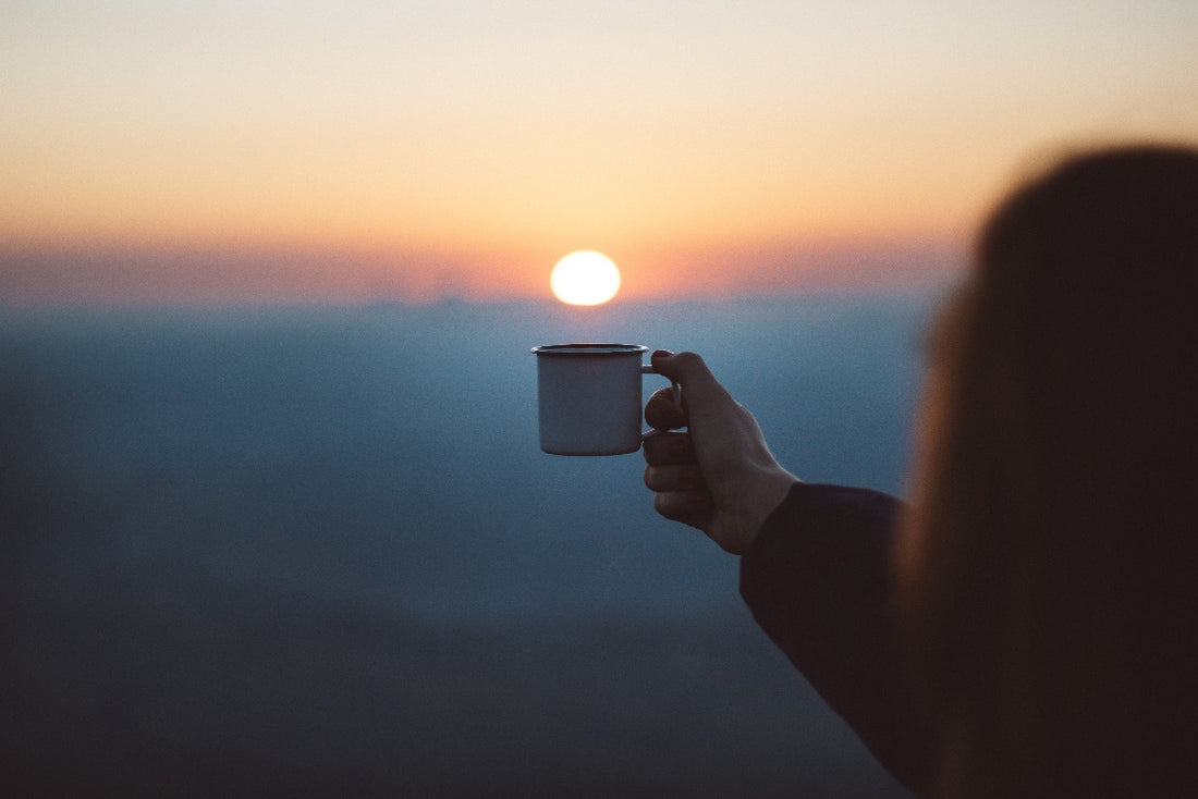 A person holding a cup of coffee
